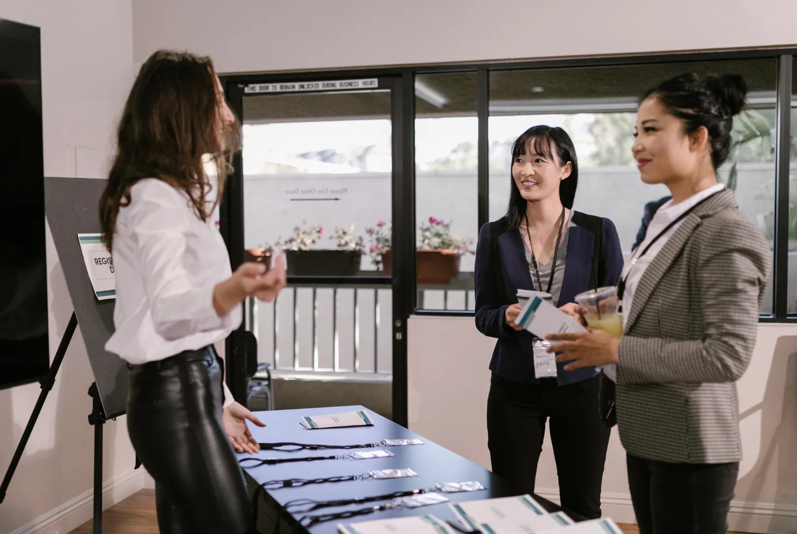 Event staff greeting delegates at a registration desk